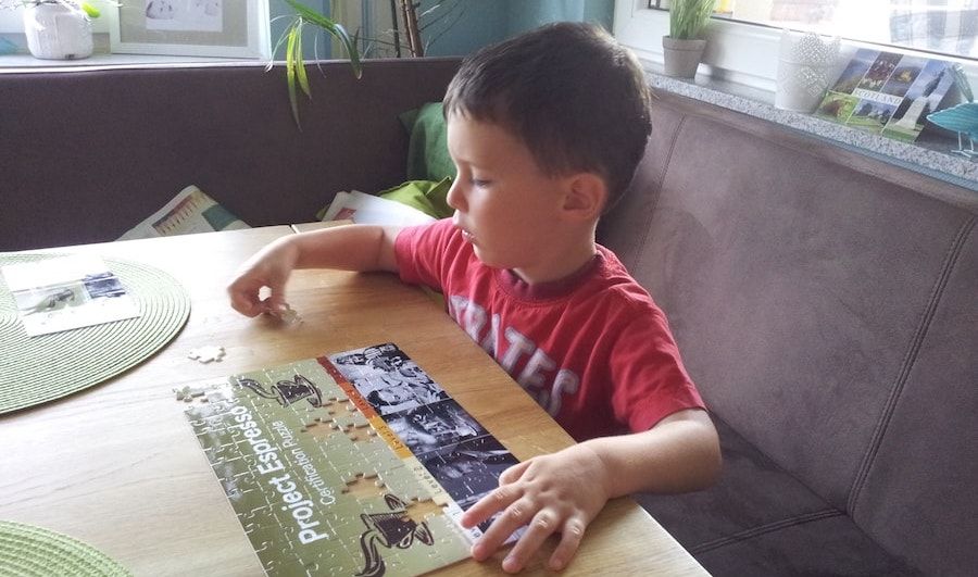 Little boy helping with the puzzles